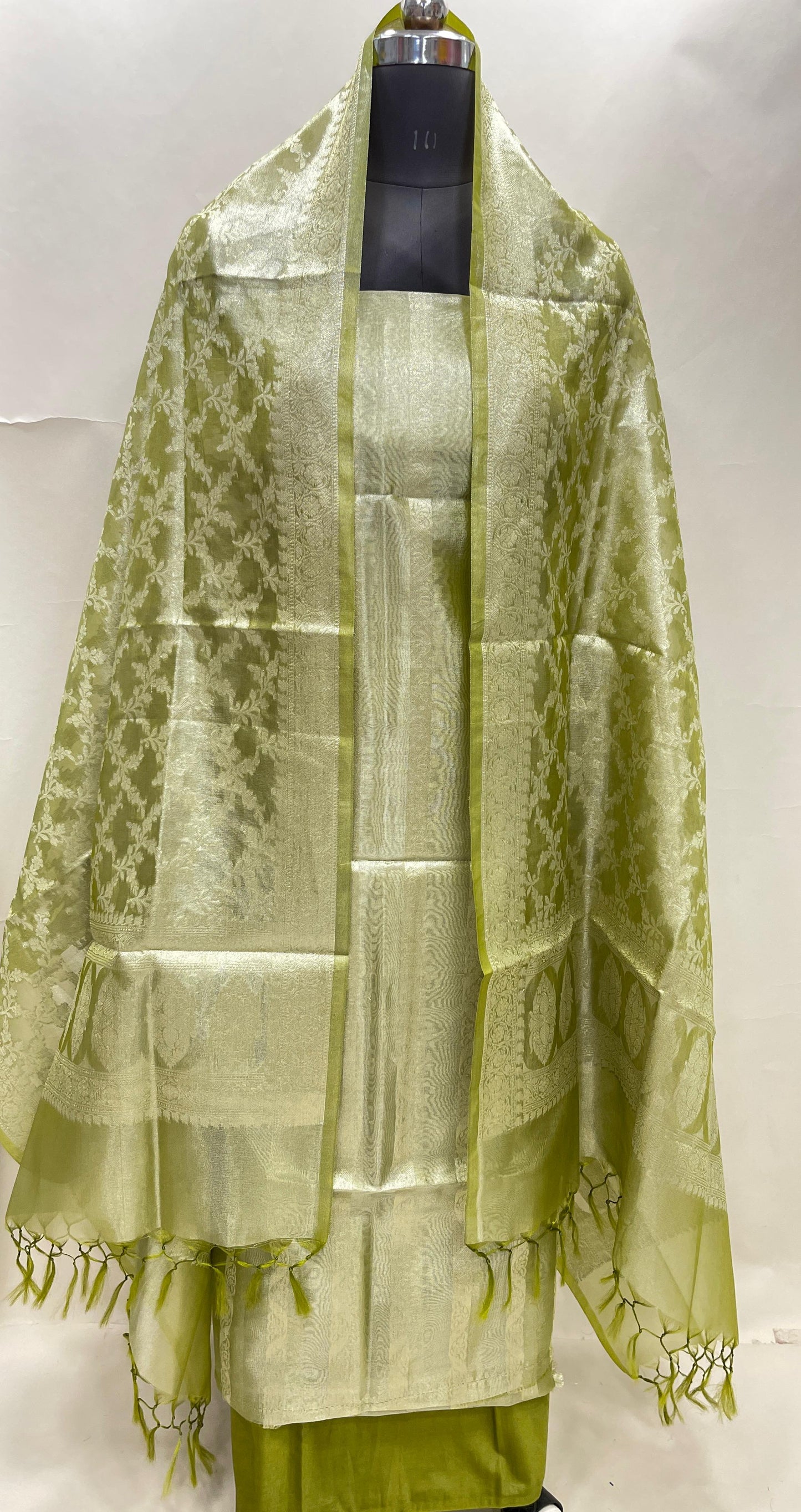 Green tissue silk suit set with floral zari stripe and green dupatta. SHL_79