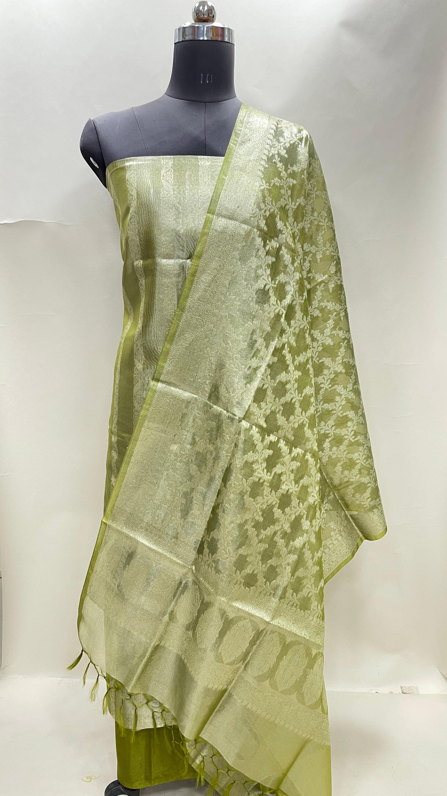 Green tissue silk suit set with floral zari stripe and green dupatta. SHL_79