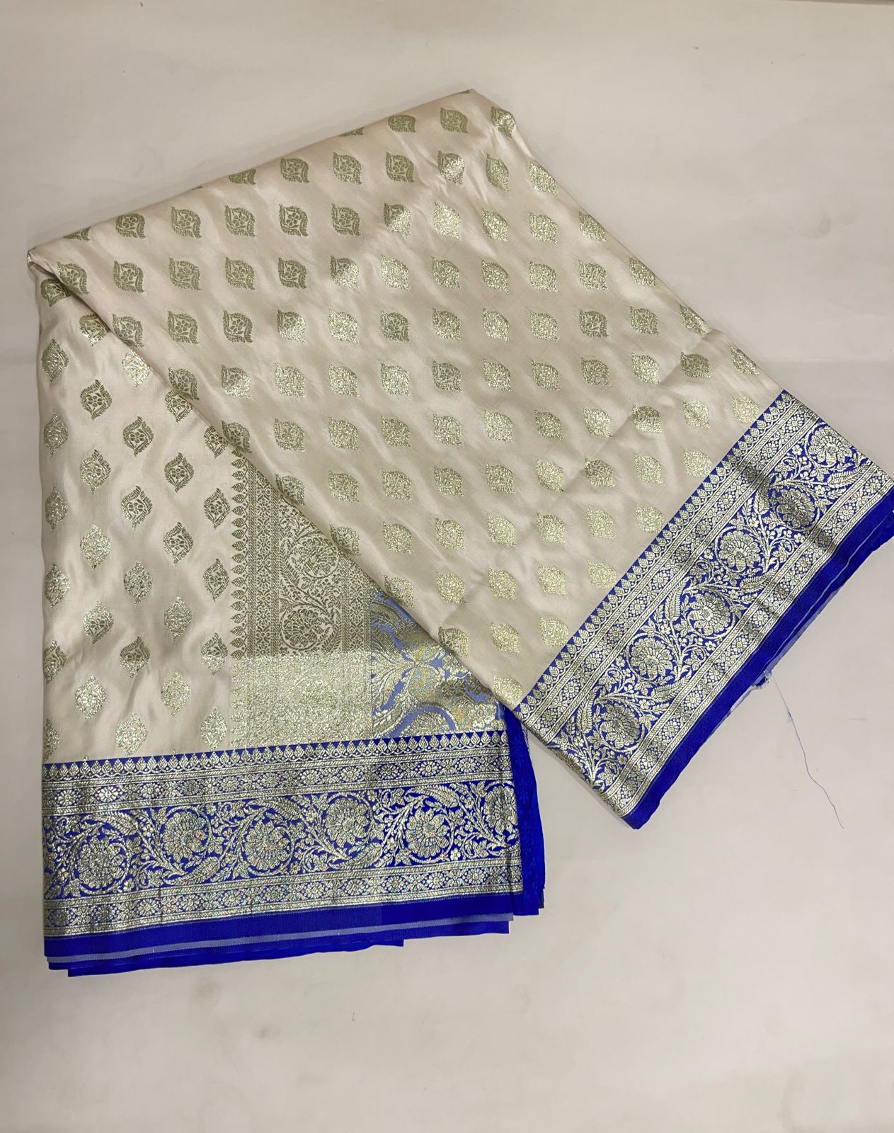 Faishana Presents Off-White Katan Silk Floral Light Gold Zari Booti with Contrast Blue Floral Pallu Banarasi saree and Blue Blouse