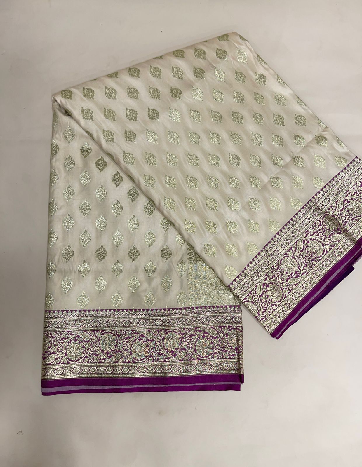 Faishana Presents Off-White Katan Silk Floral Light Gold Zari Booti with Contrast Purple Floral Pallu Banarasi saree and Purple Blouse