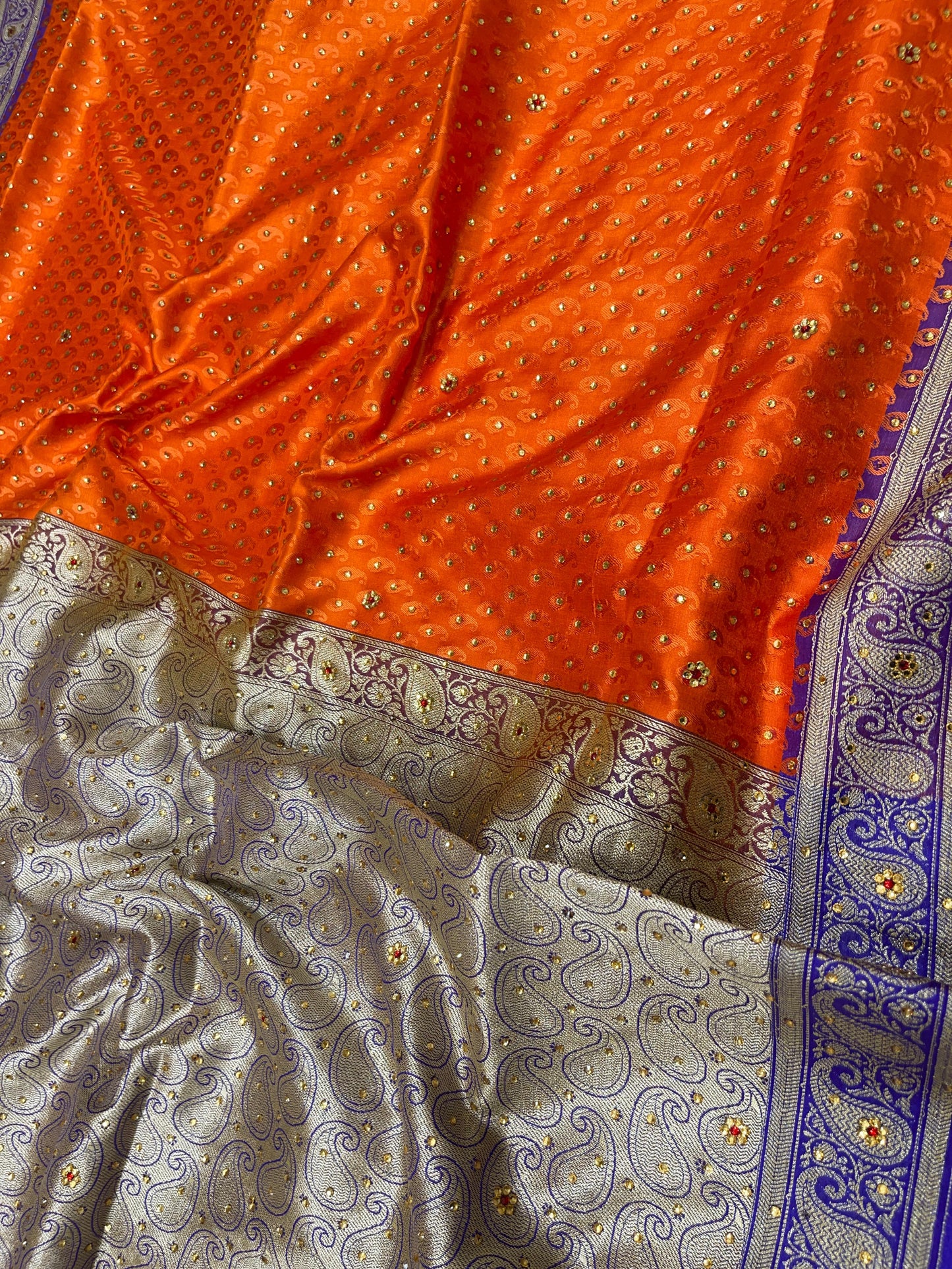 Faishana Presents Orange Tanchoi Silk Low Stone Work with Contrast Blue Pallu Zari Border and Purple Blouse