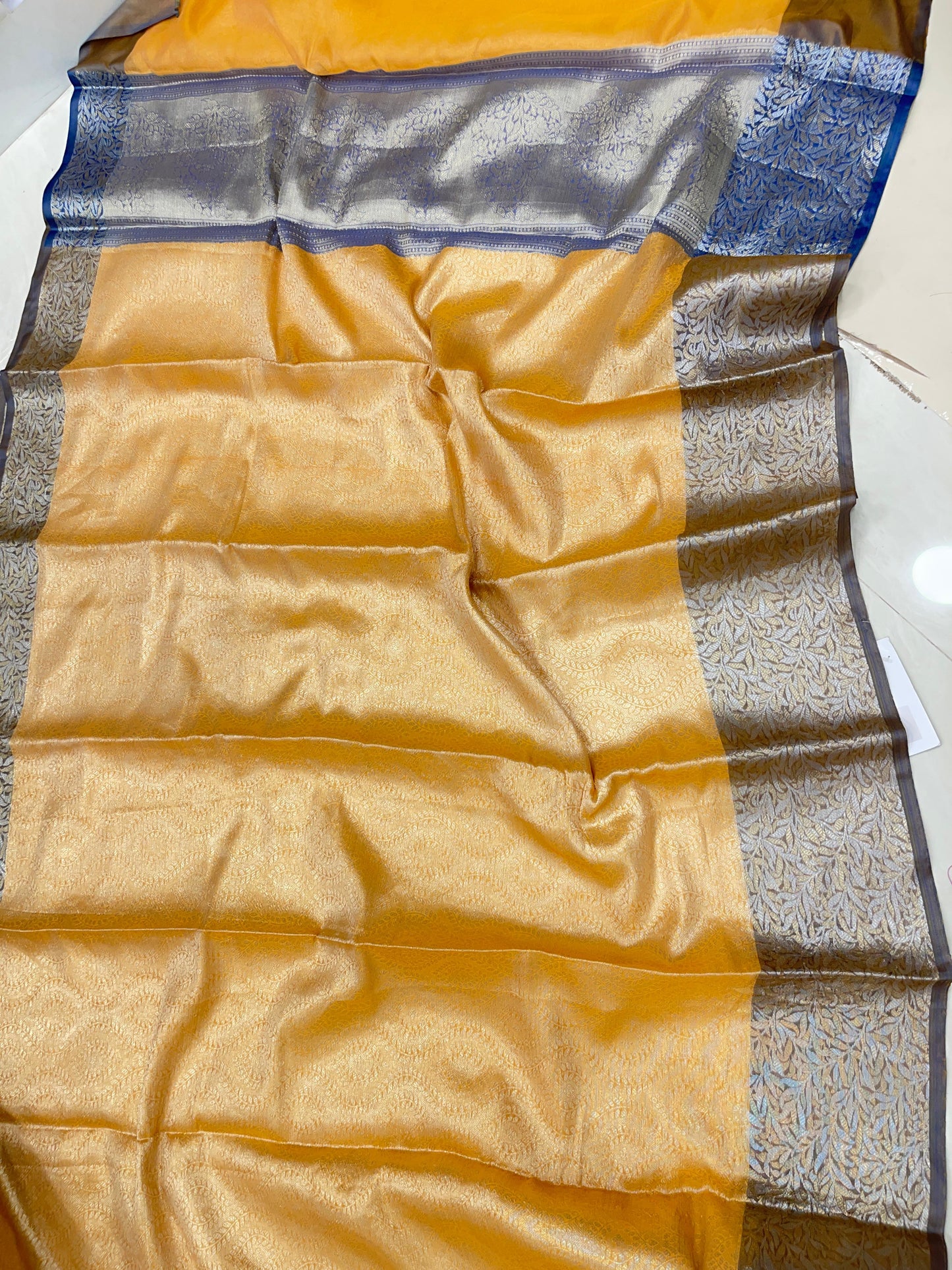 Faishana Presents Mustard Art Silk Floral Lehariya Sliver Jaal with Contrast Blue Pallu and Olive Copper Silver Jaal Zari Border with Blue Blouse