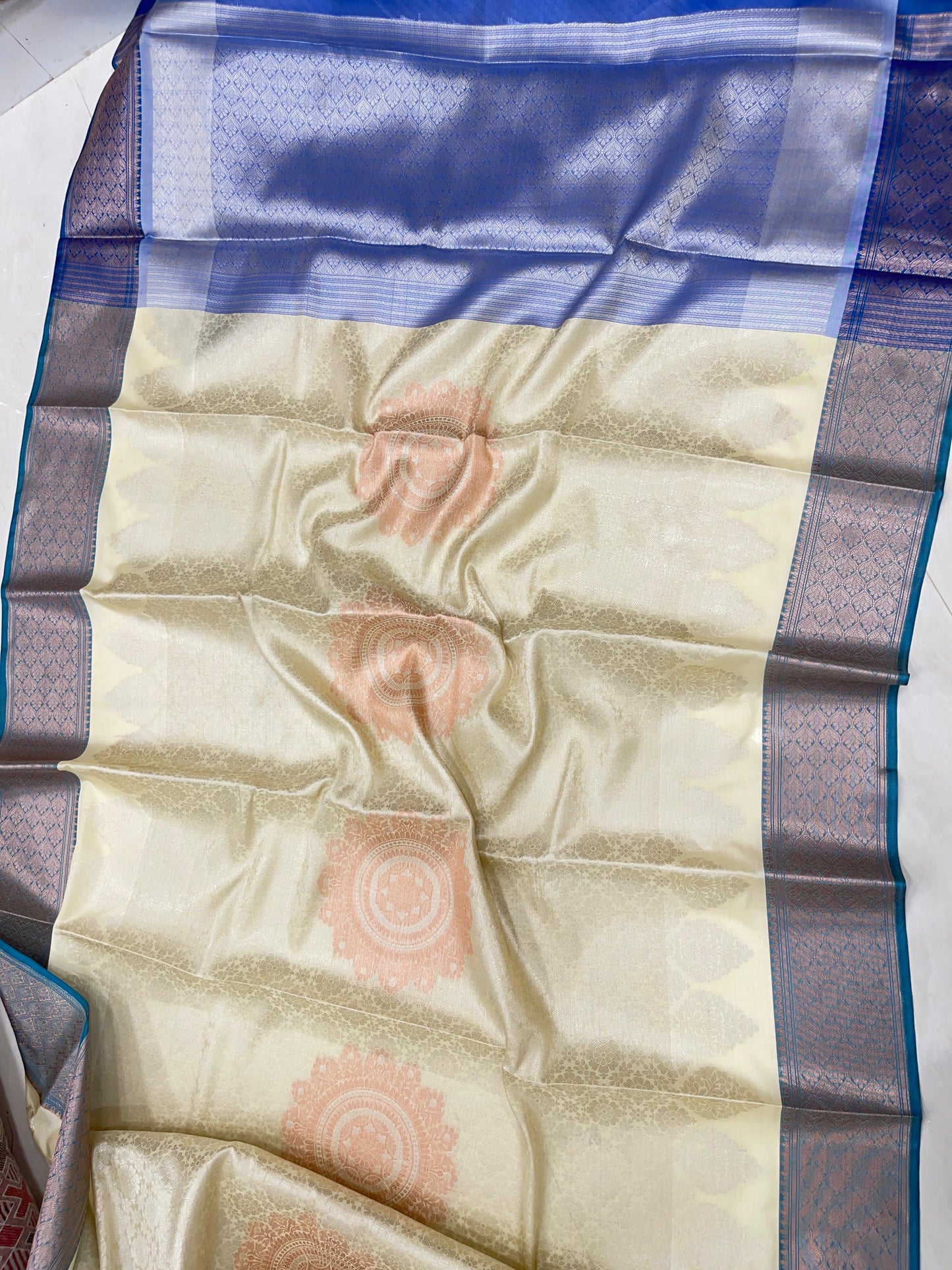 Faishana Presents Off-white Floral Mina Zari Stripe and Dual Skirt Copper and Silver Boota with Contrast Blue Pallu Blue Zari Border and Blue Blouse