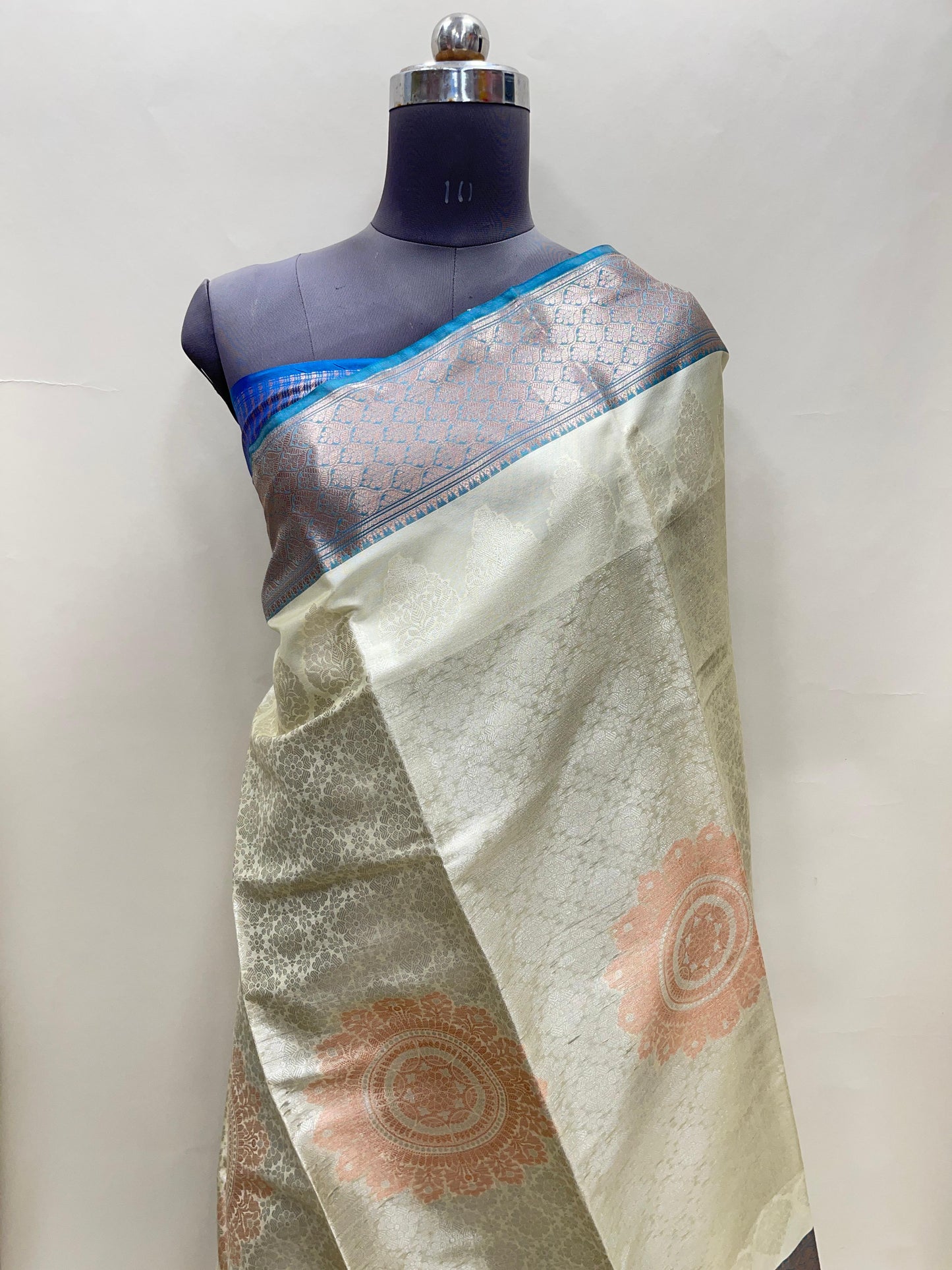 Faishana Presents Off-white Floral Mina Zari Stripe and Dual Skirt Copper and Silver Boota with Contrast Blue Pallu Blue Zari Border and Blue Blouse