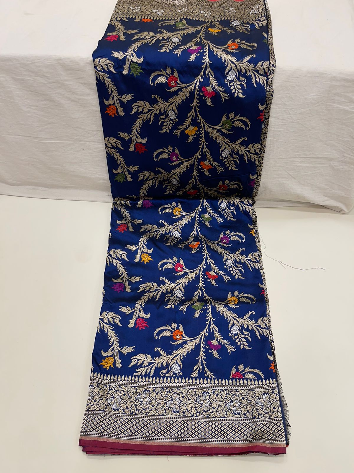 Symphony of Elegance and Tradition: Faishana Pure Handloom Navy Blue Katan Silk Multicolor Minakari Kadhwa Jaal and Zari Border with Navy Stripe Blouse