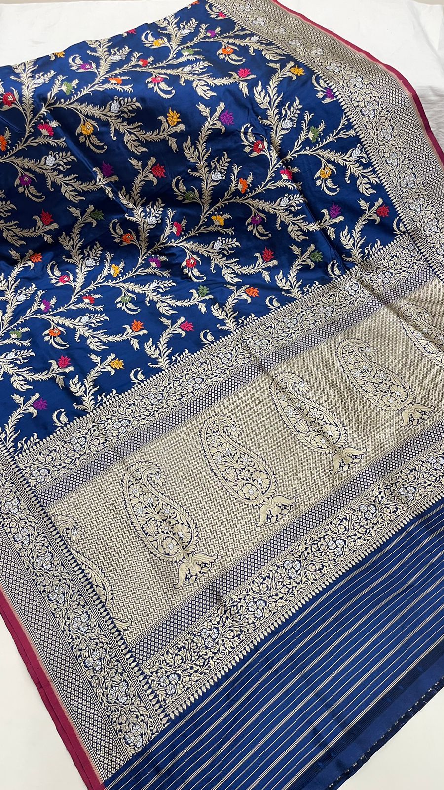 Symphony of Elegance and Tradition: Faishana Pure Handloom Navy Blue Katan Silk Multicolor Minakari Kadhwa Jaal and Zari Border with Navy Stripe Blouse