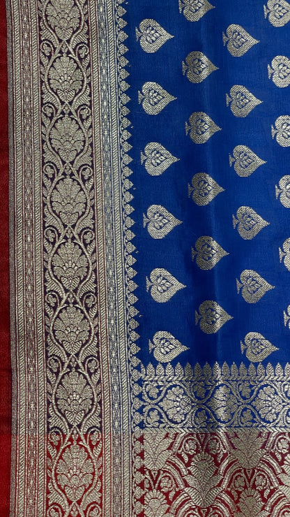 Faishana Presents Blue Satin Silk Silver Zari Pan Booti and Contrast Red Zari Border and Heavy Silver Zari Floral Anchal Banarasi Saree with Red Blouse