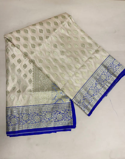 Faishana Presents Off-White Katan Silk Floral Light Gold Zari Booti with Contrast Blue Floral Pallu Banarasi saree and Blue Blouse