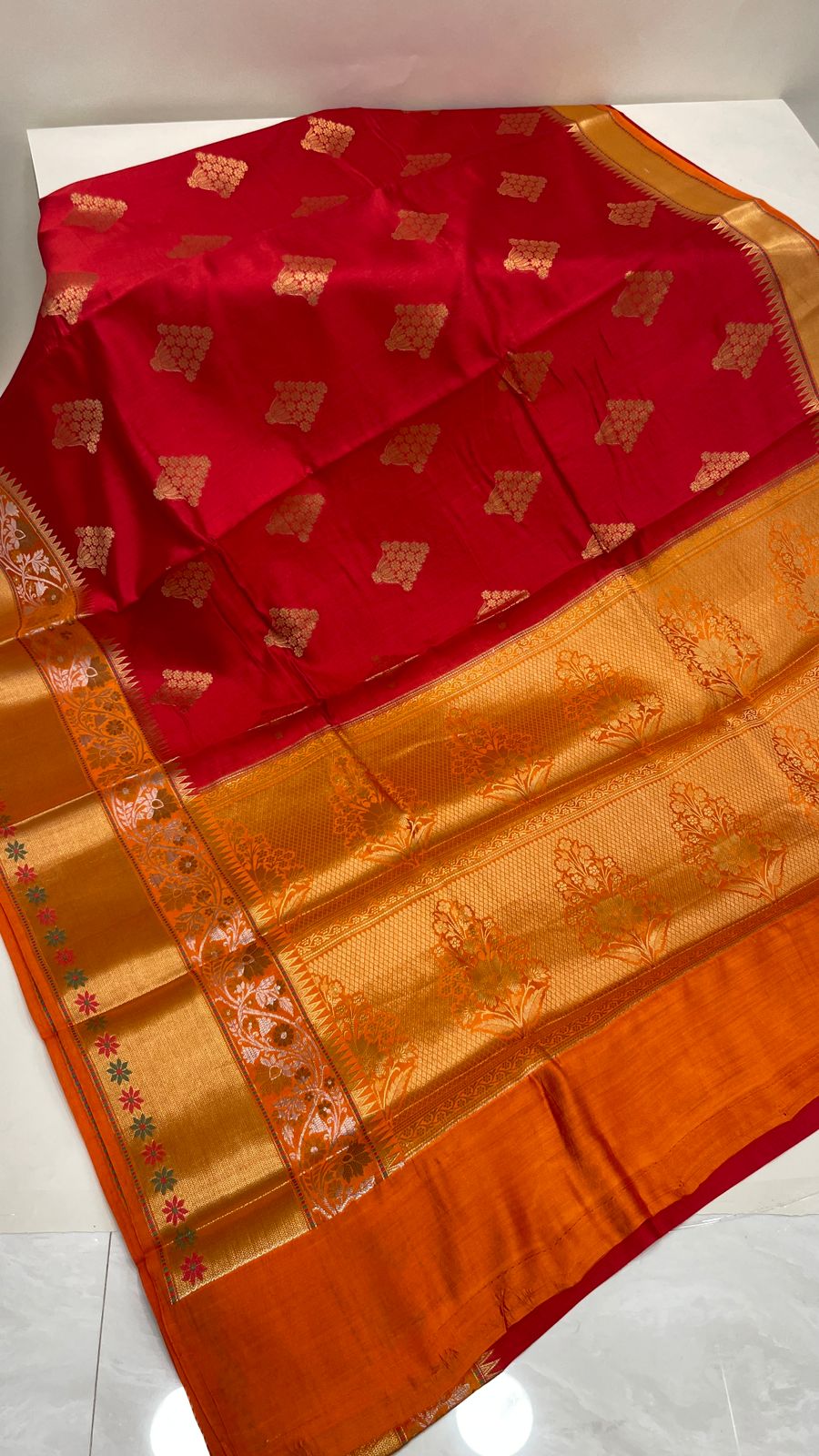 Faishana Pure Handloom Red Chiniya Silk Golden Floral Zari Booti Contrast Orange Skirt Silver Mina Zari Dual Border and Orange Floral Boota Pallu with Orange Blouse