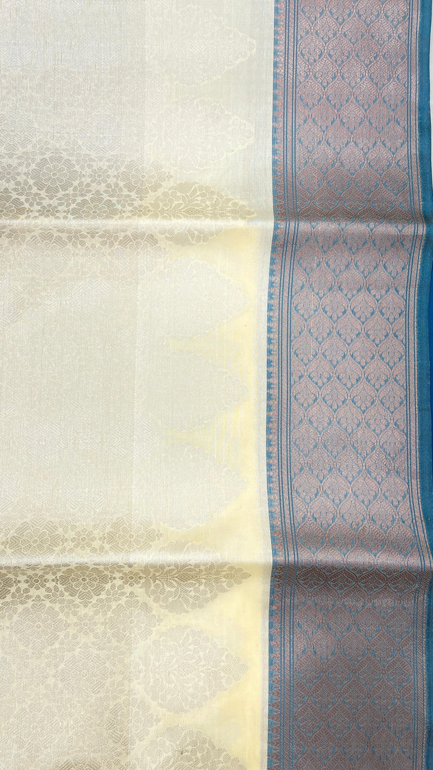 Faishana Presents Off-white Floral Mina Zari Stripe and Dual Skirt Copper and Silver Boota with Contrast Blue Pallu Blue Zari Border and Blue Blouse