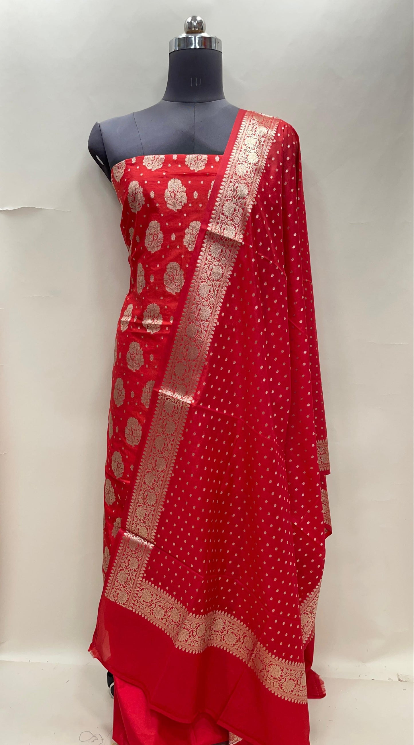 Red semi-georgette suit set featuring floral silver zari bootis and matching dupatta. SHL_43